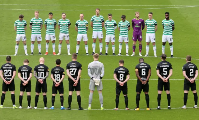 Celtic and Livingston players stand in the centre circle