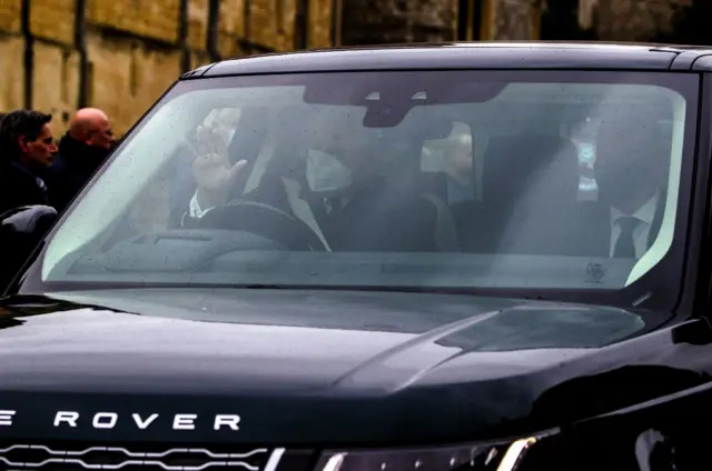 Prince Andrew waves to the crowds as he leaves Windsor Castle