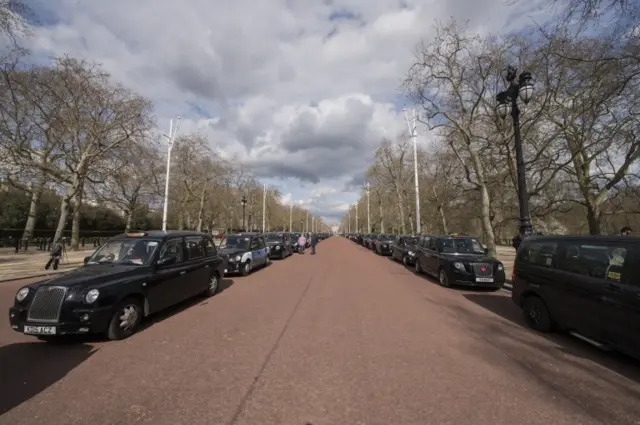 Black London taxi cabs line The Mall near Buckingham Palace, London, to pay tribute to the Duke of Edinburgh, on 9 April 2021