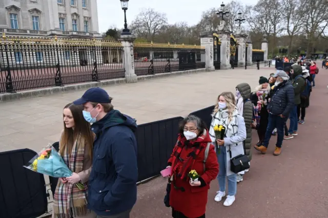 People gather outside Buckingham Palace a day after the passing of Prince Philip, Duke of Edinburgh, in London, on 10 April 2021