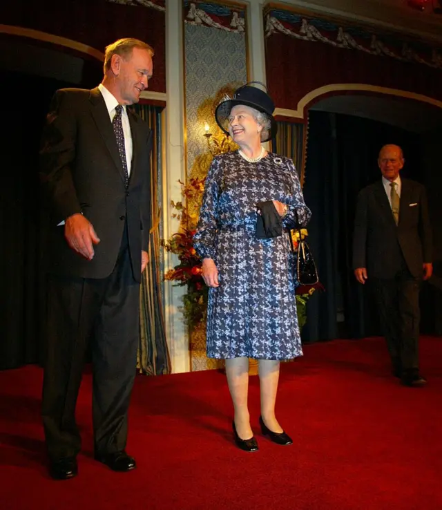 Queen Elizabeth II is greeted by Canadian Prime Minister Jean Chretien (L) as the queen's husband Prince Philip (R) looks on before an official luncheon in Vancouver, Canada, 7 October 2002