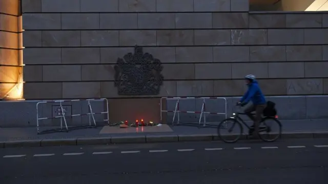 A cyclist passes a commemoration site for Britain"s Prince Philip, husband of Queen Elizabeth, who died at the age of 99, at the British Embassy in Berlin