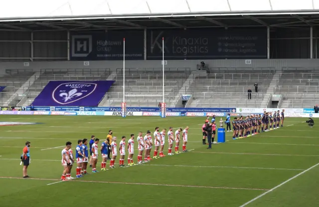 St Helens and Leeds Rhinos players stand for a two minute silence prior to kick off