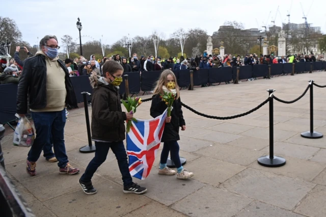 People gather outside Buckingham Palace a day after the death of the Duke of Edinburgh