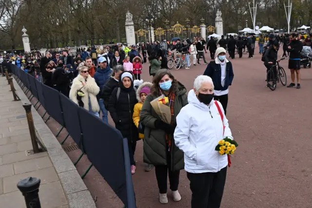 People gather outside Buckingham Palace a day after the death of the Duke of Edinburgh