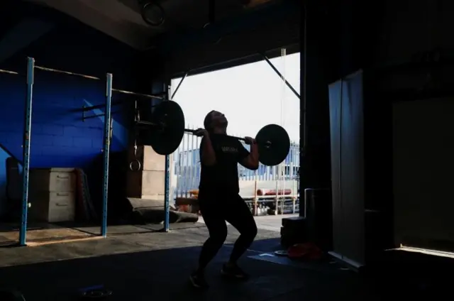 Weight training in front of open door