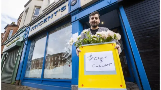 Gerry Keating, store manager of the St Vincent de Paul charity shop on Belfast's Ormeau Road, getting ready for business