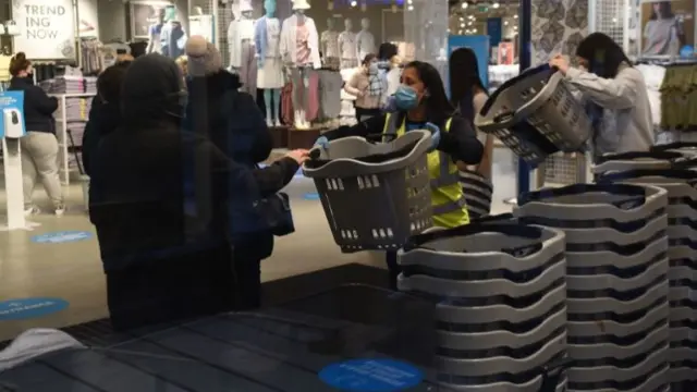 Shoppers getting baskets inside the Primark