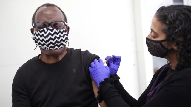 A man gets the second dose of a coronavirus vaccine