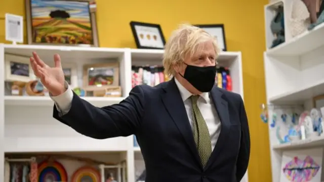 British Prime Minister Boris Johnson wearing a protective mask as he visits a shop in Cornwall