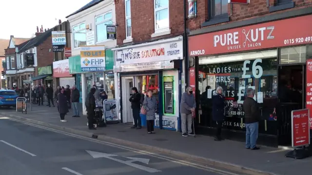 Queue outside a barber shop in Arnold