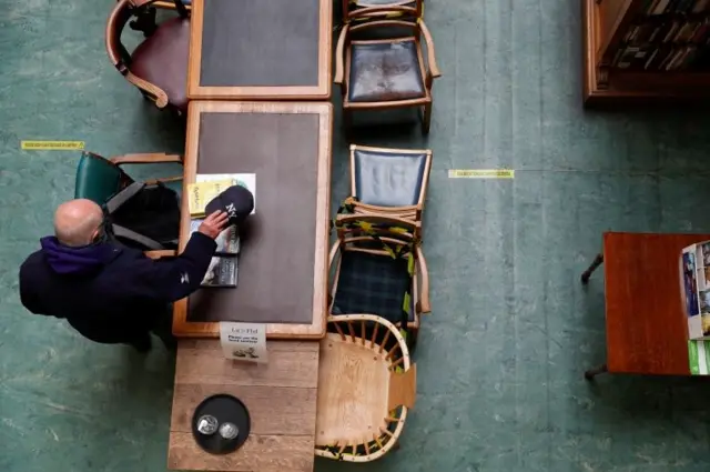 Overhead picture of desk showing some chairs taped off