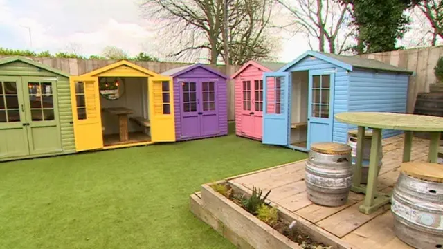 Beach huts in a pub beer garden