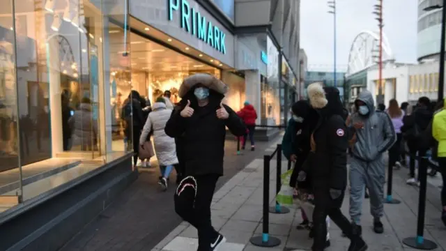 Early morning shoppers stand in line outside Primark, Birmingham