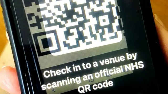 A picture of a phone showing a QR code