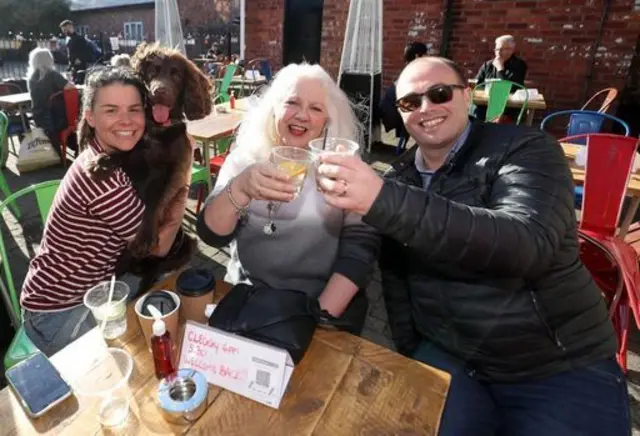 Naomi Wright with dog, Otto Bear Wright, Val Pallister and Sam Jeffs enjoy a drink at Dexter and Jones gin bar in Knutsford, Cheshire