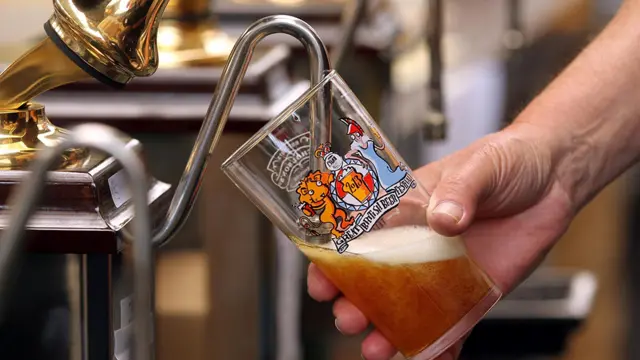 Barman pouring pint of beer