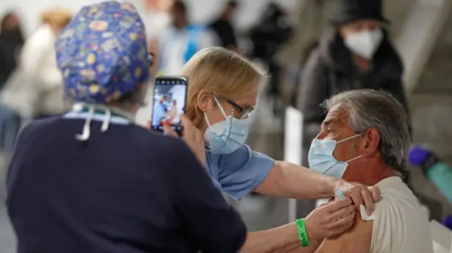 A person receives a dose of vaccine at the Wizink Center sports pavilion in Madrid, central Spain, 09 April 2021