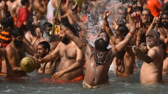 Indian men splashing around in the Ganges river