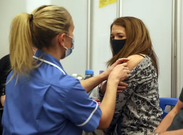 A woman receives a vaccine in Reading, Berkshire