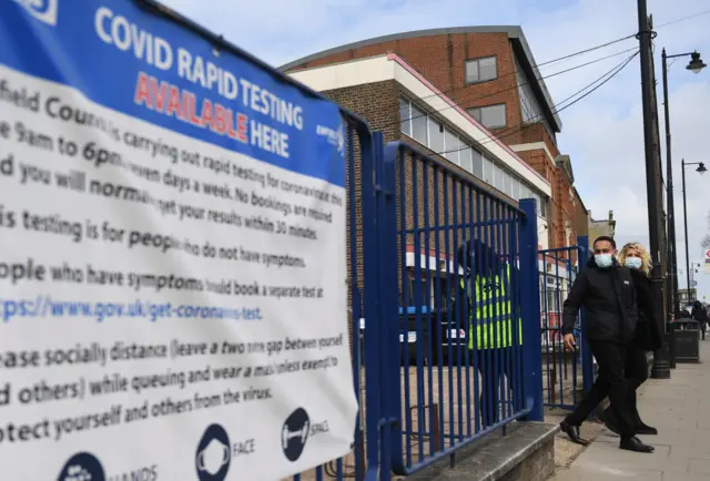 People leave a rapid coronavirus testing centre in London, 5 April 2021.