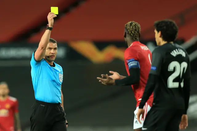 Paul Pogba is shown a yellow card