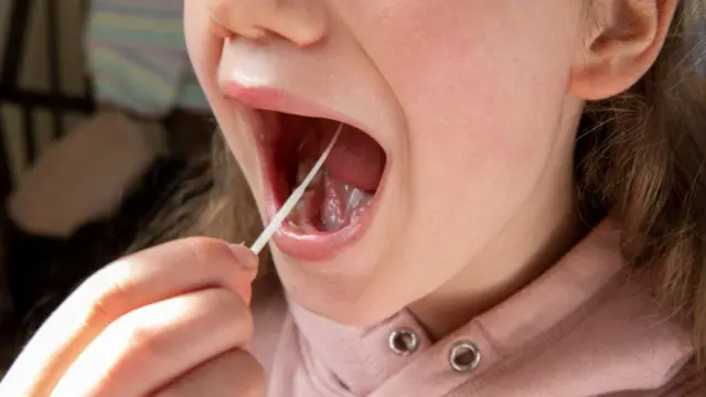 A woman taking a swab test