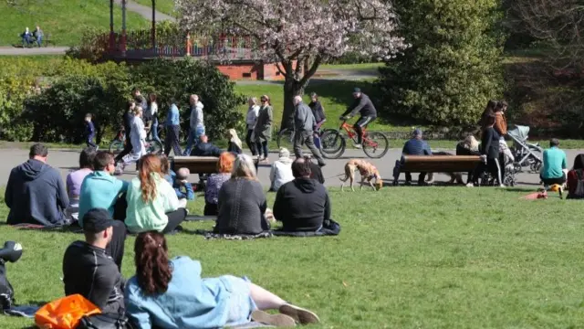 People enjoying the sunny weather in a park