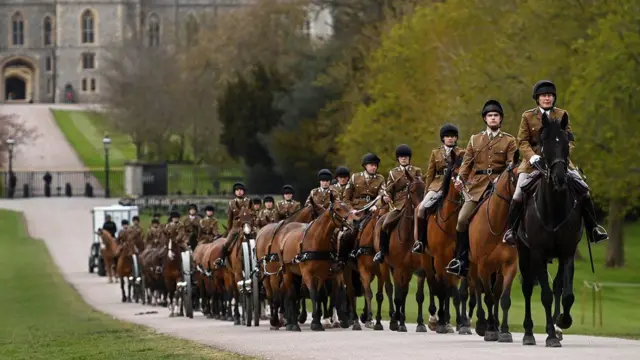 Members of the King's Troop Royal Horse Artillery ride along the Long Walk