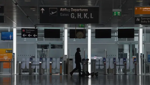 A passenger walks in a terminal of the Franz-Josef-Strauss airport in Munich, southern Germany