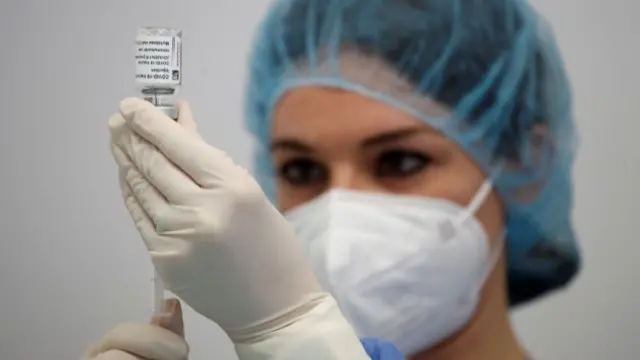 A nurse prepares a dose of AstraZeneca coronavirus vaccine in Fasano Italy