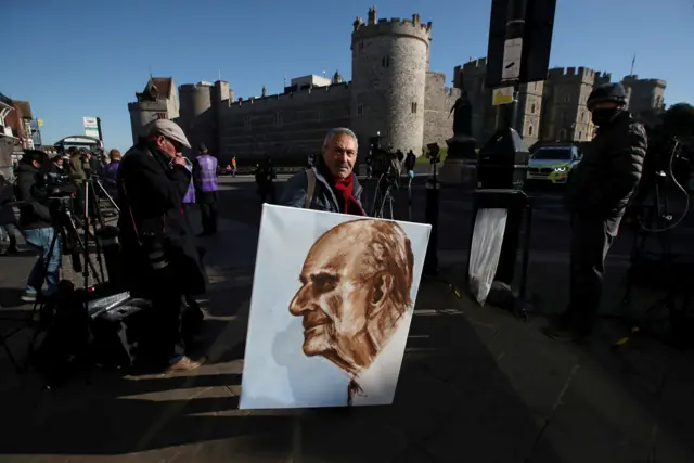 Artists Kaya Mar in Windsor with his painting of Prince Philip