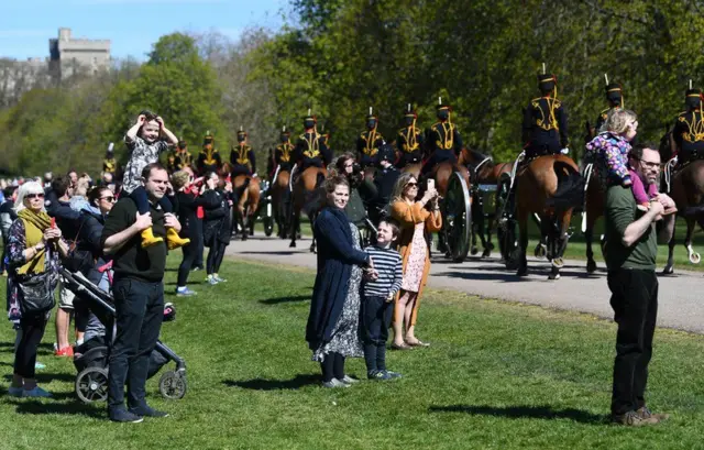 Hundreds of people watched on as the King's Troop Royal Horse Artillery made their way along the Long Walk up to Windsor Castle at midday.  Dozens of riders, wearing black, gold and red uniforms and carrying three guns, rode up to the castle's Cambridge Gate.