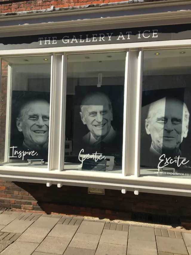 Pictures of Prince Philip in the window of a Windsor art gallery