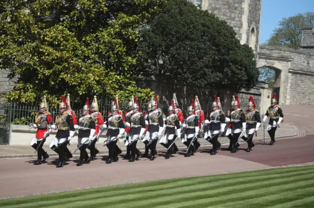 A dismounted detachment of The Life Guards and The Blues Royals of The Household Cavalry arrive at Windsor Castle