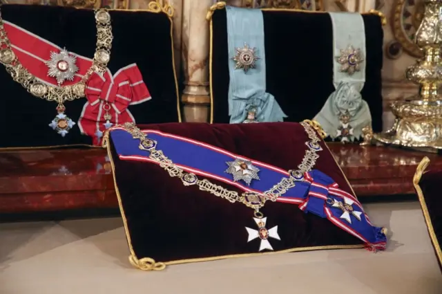 Insignia belonging to the Duke of Edinburgh, the Royal Victorian Order Collar and Badge, and the Royal Victorian Order Breast Star and Badge (front) and The Order of the Elephant (Denmark), and the Order of the Redeemer (Greece), placed on the altar in St George"s Chapel, Windsor,