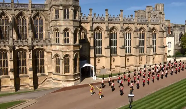 Members of the military arriving at the castle