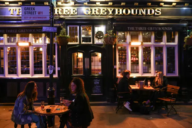 People outside a pub in London on Saturday evening