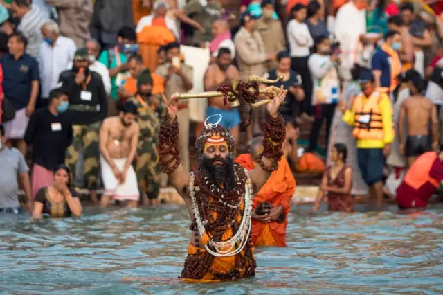 People bathe in the Ganges river during the ongoing religious Kumbh Mela festival in Haridwar on April 12, 2021