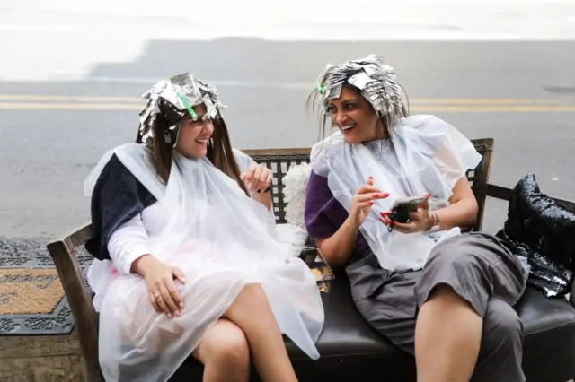 Women sit on the street in Israel