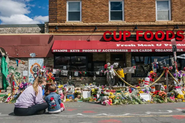 Kelsey Romero teaches her daughter Liliana, 3, of George Floyd's death in the intersection of 38th Street & Chicago Avenue on April 17, 2021 in Minneapolis, Minnesota.