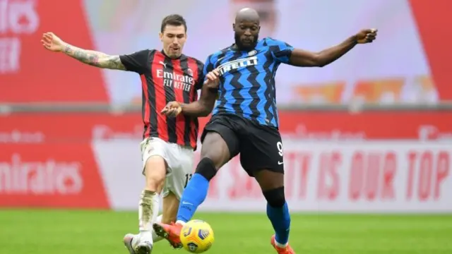 AC Milan's Alessio Romagnoli challenges Inter Milan's Romelu Lukaku