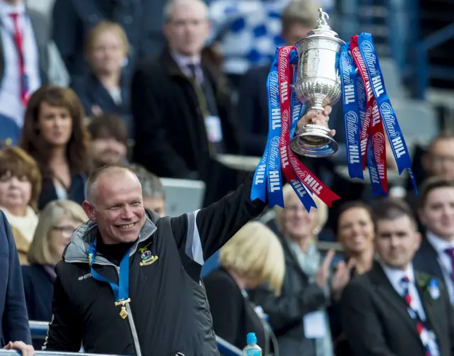 ICT manager John Hughes celebrates with the cup