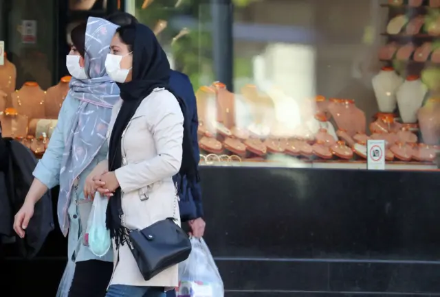 Women walk in Tehran