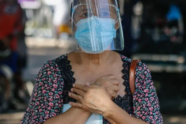 A woman attends church in the Philippines