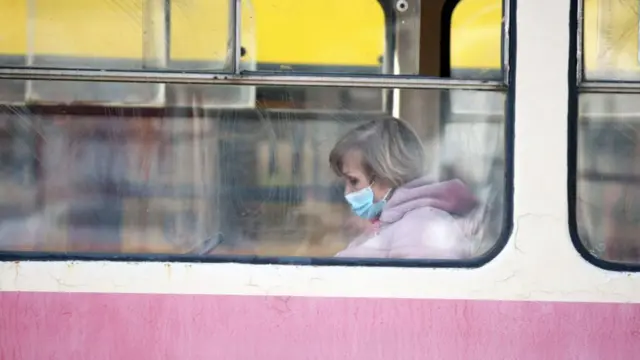 A woman in a face mask sits on the tram as quarantine restrictions are in place due to the spread of COVID-19, Kyiv, capital of Ukraine