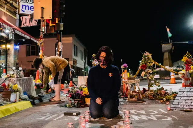 Courteney Ross, girlfriend of George Floyd, lays candles at George Floyd Square in Minneapolis