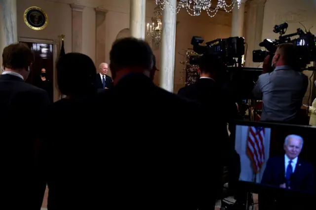 White House reporters listen to Joe Biden