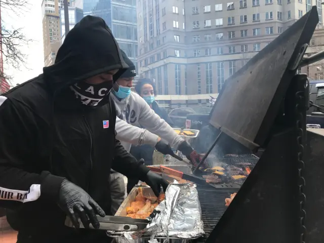 A man grills food outside a Minneapolis court