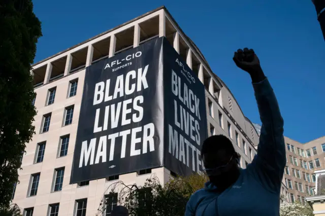 A person celebrates the verdict of the Derek Chauvin trial at Black Lives Matter Plaza near the White House on April 20, 2021 in Washington, D.C.